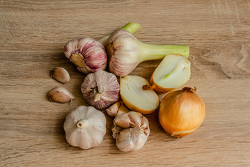 healthy vegetables: onions and garlic on wooden background close-up