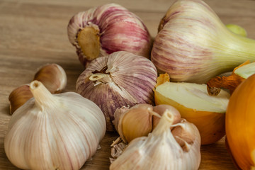 healthy vegetables: onions and garlic on wooden background close-up