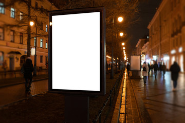 Vertical billboard in the city at night. Advertising luminous billboard