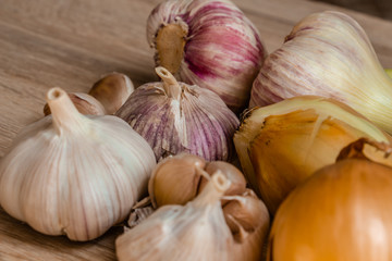healthy vegetables: onions and garlic on wooden background close-up