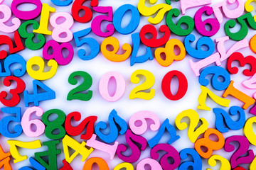 Numbers 2020 among randomly scattered, isolated on a white background. Close up.