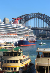 Busy Sydney harbour, a cruise ship moored and being refuelled, public ferries and the harbour...