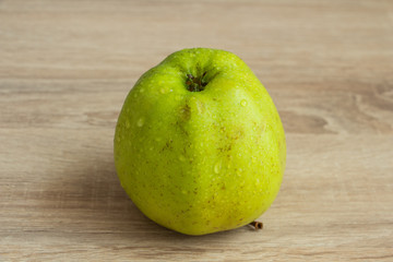 juicy green apple on a wooden table