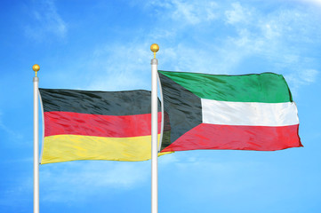 Germany and Kuwait two flags on flagpoles and blue cloudy sky