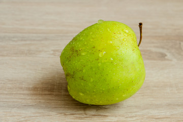 juicy green apple on a wooden table