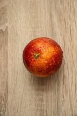 juicy red orange on a wooden table, exotic fruit,  vertical shot