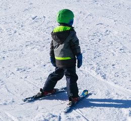 snowy ski slope full of skiers and snowboarders