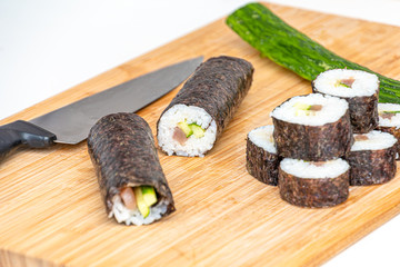 Sushi roll Japanese food rolls on bamboo kitchen board