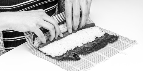Sushi roll Japanese food tuna cucumber preparing ingredients rolled in algae sheet in black and white