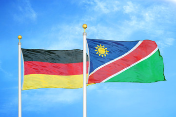 Germany and Namibia two flags on flagpoles and blue cloudy sky