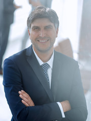 Portrait of confident businessman on office background