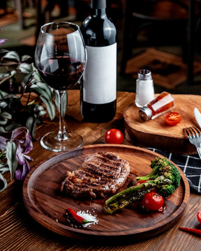 fried meat with vegetables and red wine