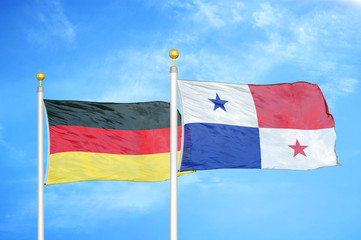 Germany and Panama two flags on flagpoles and blue cloudy sky