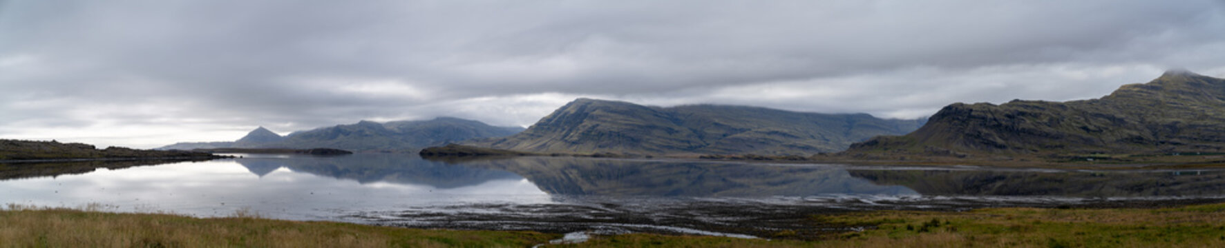 Panorama of the sea and mountains, a typical landscape in Iceland.