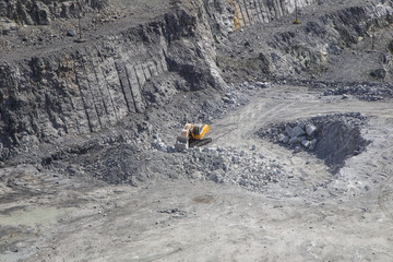 Working mining excavator mechanical shovel in magnezite ore quarry open pit