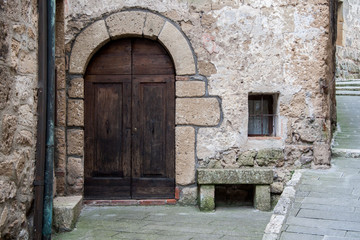Closed entrance to a stone building with a wooden door