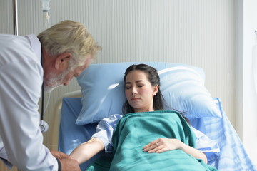 The doctor is examining the patient and encouraging the patient to stay in the hospital.