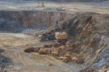 Working mining excavator mechanical shovel in magnezite ore quarry open pit