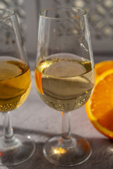 Glasses with cold dry fino and sweet cream sherry fortified wine in sunlights, andalusian style interior on background