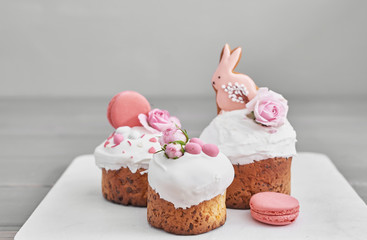 Easter orthodox sweet bread, Easter cake with flowers and gingerbread. Holidays breakfast concept with copy space. Easter greeting card template. Homemade pasques.Easter sweets on grey background.