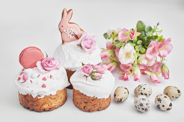 Easter sweet bread, Easter cake with flowers, eggs and gingerbread. Holidays breakfast concept with copy space. Easter greeting card template. Homemade pasques.Easter sweets on white background.