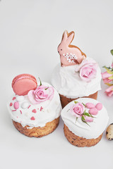 Easter orthodox sweet bread, Easter cake with flowers and gingerbread. Holidays breakfast concept with copy space. Easter greeting card template. Homemade pasques.Easter sweets on white background.