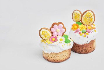 Easter orthodox sweet bread, Easter cake with flowers and gingerbread. Holidays breakfast concept with copy space. Easter greeting card template. Homemade pasques.Easter sweets on white background.
