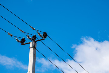 Electric pole against the sky, electric cable.