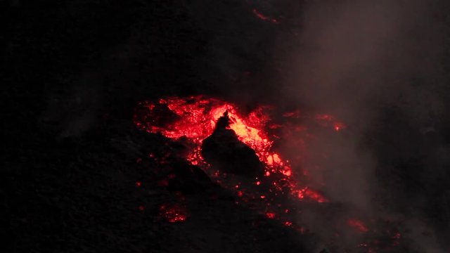 Big chunks or molten rocks break loose from a clumpy lava flow and tumble down the volcano.