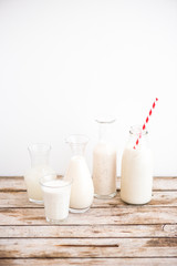 Selection of vegan plant based milks with red striped paper straw, Rice, Oat, Almond, Cashew