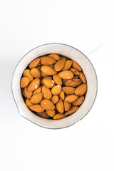 Raw Almonds in White Enamel Pan