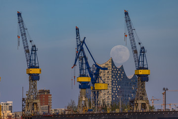 Fototapeta na wymiar Hamburg/Hamburg/Germany-04072020: Full moon in the harbour over the Elbphilharmonie
