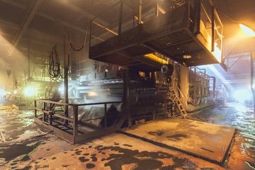 General view of the sinter plant. Submission of iron ore for sintering before entering the blast furnace. Metallurgical production. Day panorama - Powered by Adobe