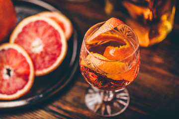 Orange whiskey sour cocktail with bourbon, blood orange juice and simple syrup
