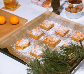 Confectionery - still life. Cookies, bakery products, tangerines, eggs. Cooking dessert and sweets. Sugar and cafe. Coffee or tea to buns. Still life with food