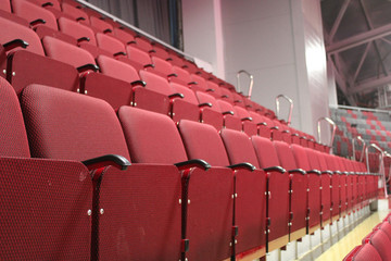 Empty auditorium. Hinged seats. Red chairs in the cinema.