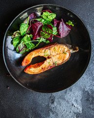 pink salmon steak fried and salad,
grilled seafood, pescatarian Menu concept food background keto or paleo diet. top view. copy space for text