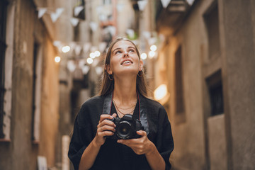 Outdoor summer smiling lifestyle portrait of pretty young woman having fun taking pictures in the...