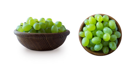 Green grapes Kishmish isolated on white. Top view. Grapes in a wooden bowl isolated on white. Green grapes Kishmish with copy space for text. Grapes from different angles isolated on white background.