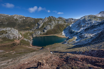 Saliencia lakes in the Somiedo Nature Park, Asturias, Spain. Top view of the Lago de la Cueva at the end of winter, snowy areas in the mountains.