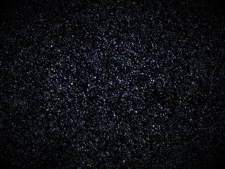 Black asphalt texture. Surface road abstract background. Grains close up pattern.