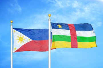 Philippines and Central African Republic two flags on flagpoles and blue cloudy sky