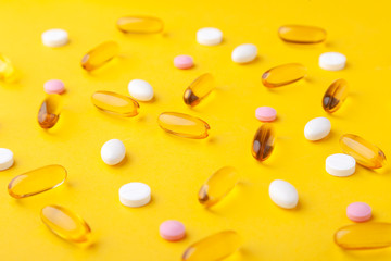 Many scattered pharmaceutical medicine vitamins, pills, fish oil softgel, tablets