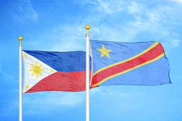 Philippines and Congo Democratic Republic two flags on flagpoles and blue cloudy sky