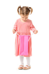 Cute little girl with shopping bag on white background