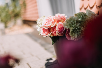 Colorful classical bouquet of roses on soft background in sunlight