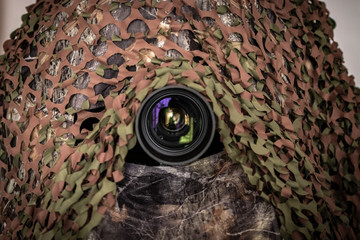 camouflage material nature photographers. Hide chair with tripod and telephoto lens