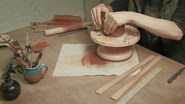 Ceramist work in the workshop.