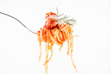 Spaghetti bolognese sprinkled with cheese and decorated with a rosemary twig on a fork on a white background	

