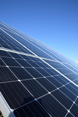 Solar panels against blue sky background.Against The Deep Blue Sky in suny weather